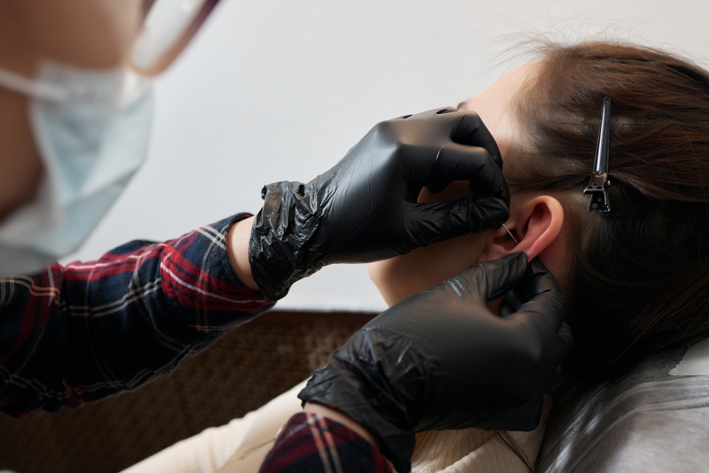 Piercings,on,an,ear.,conch,and,helix,piercings,close,up.